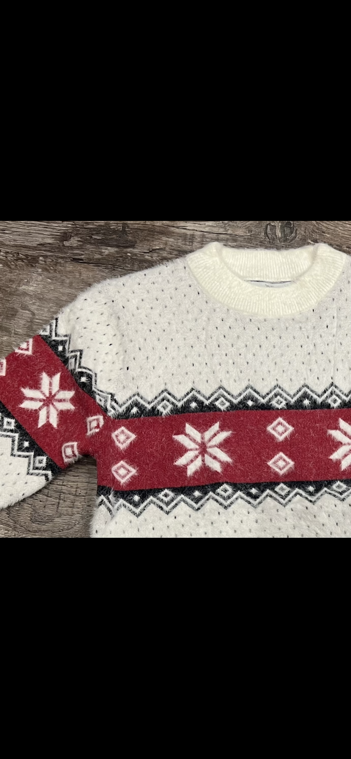 Girls ivory crew neck sweater with red and black winter detail.
